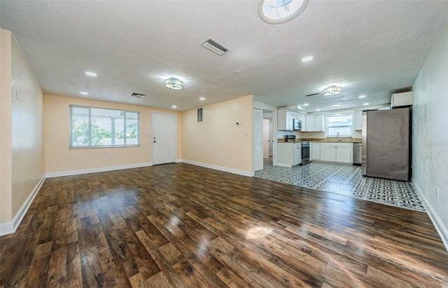 unfurnished living room featuring hardwood / wood-style flooring