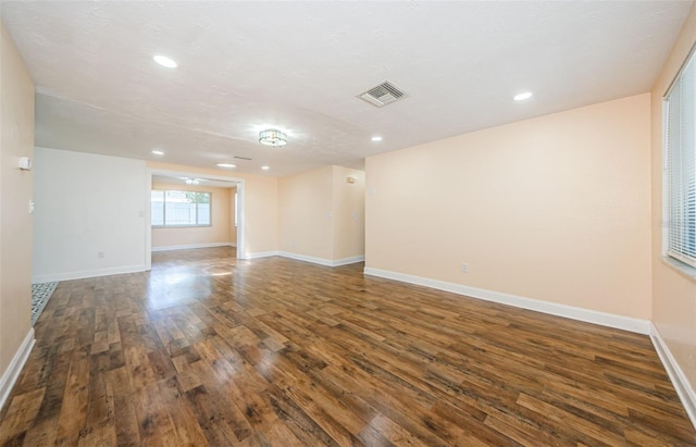 spare room with dark hardwood / wood-style floors