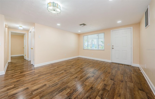 unfurnished room featuring dark hardwood / wood-style flooring