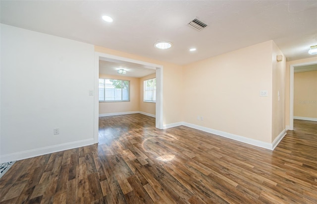 unfurnished room with dark hardwood / wood-style flooring