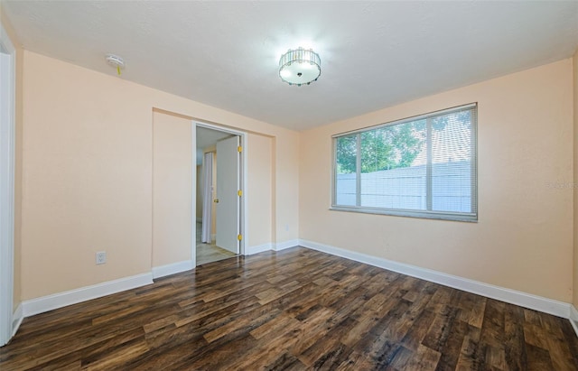 empty room with dark wood-type flooring