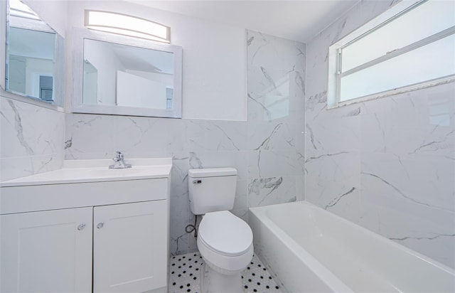 full bathroom featuring tile walls, oversized vanity, toilet, tile floors, and tiled shower / bath