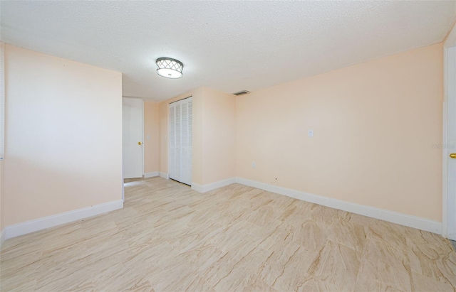 spare room with a textured ceiling