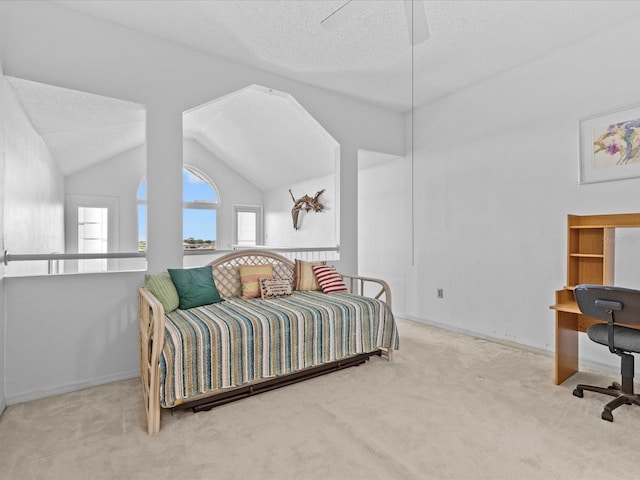 bedroom with light colored carpet, vaulted ceiling, a textured ceiling, and baseboards