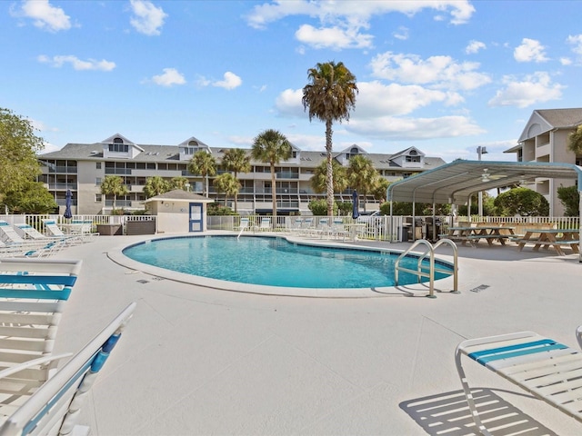 community pool featuring a patio and fence