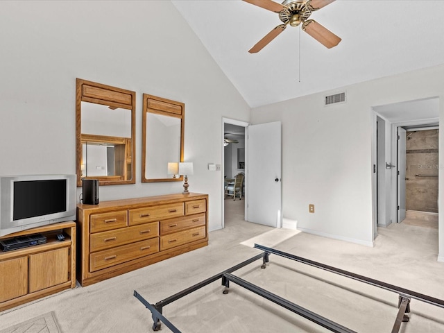 carpeted bedroom with connected bathroom, ceiling fan, and high vaulted ceiling