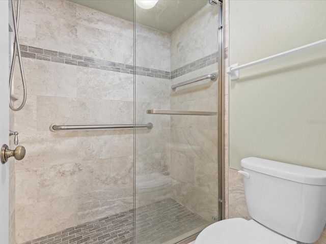 full bath with a shower stall and toilet