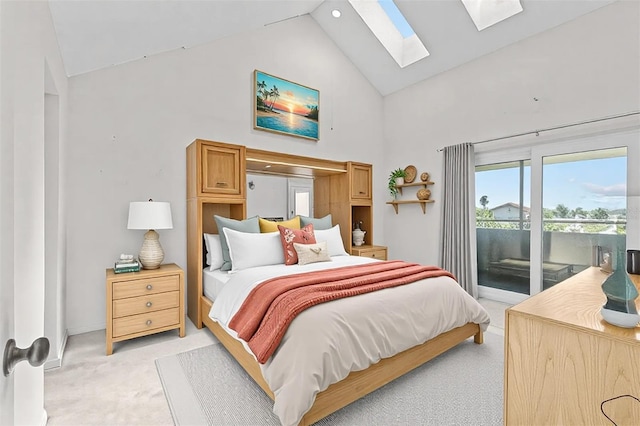 bedroom with a skylight, access to outside, high vaulted ceiling, and light colored carpet