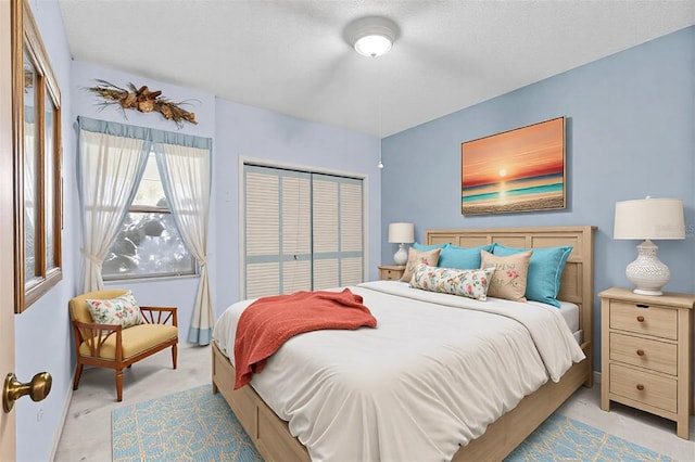 bedroom with light carpet and a textured ceiling