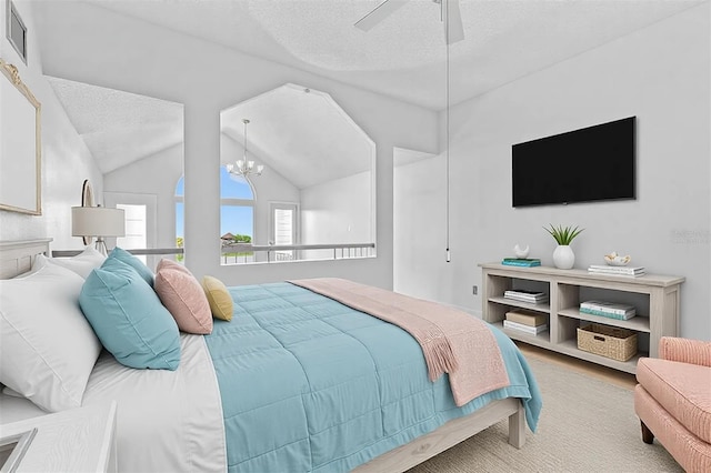 bedroom with visible vents, lofted ceiling, wood finished floors, a textured ceiling, and ceiling fan with notable chandelier