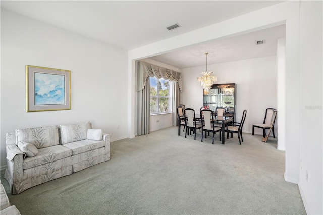 dining area featuring a chandelier and light colored carpet