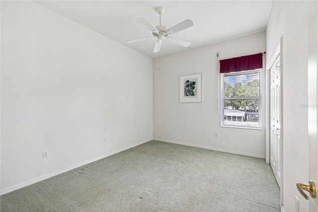 unfurnished room featuring light carpet and ceiling fan