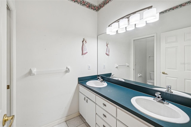 bathroom featuring tile patterned flooring, vanity, and toilet