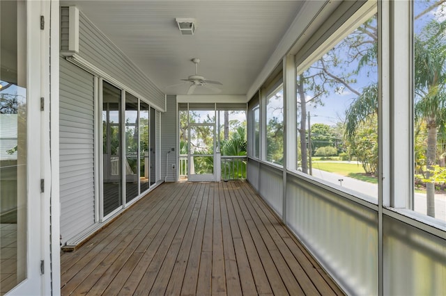 unfurnished sunroom with plenty of natural light and ceiling fan