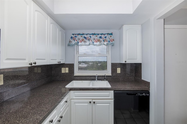 kitchen with black dishwasher, sink, white cabinets, and decorative backsplash