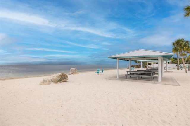 view of property's community with a view of the beach and a water view