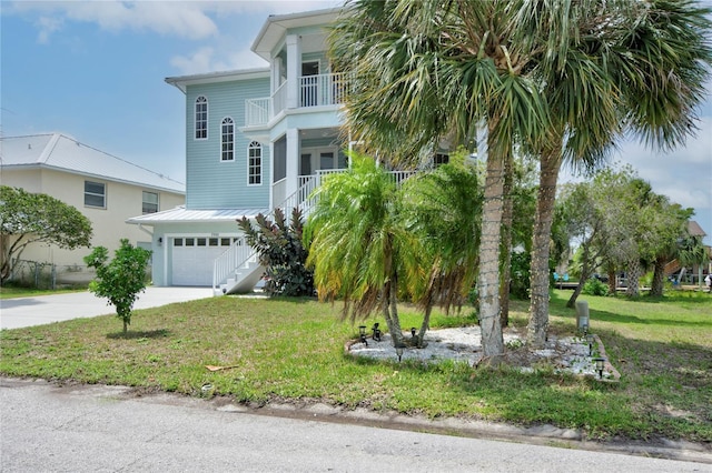 view of front facade with a front lawn, a garage, and a balcony