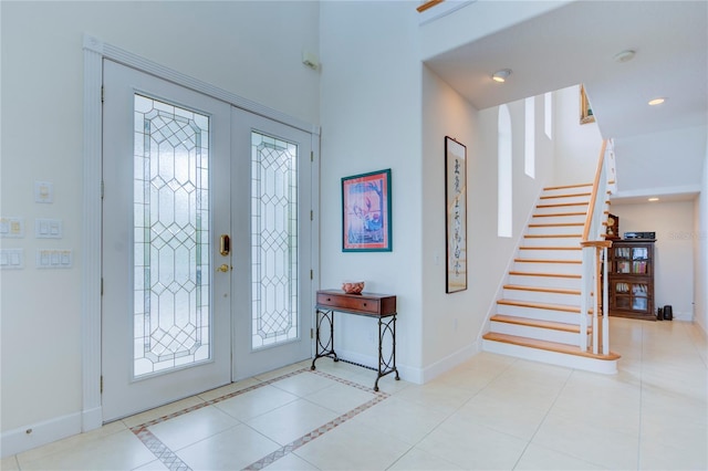 entrance foyer with light tile patterned flooring and french doors