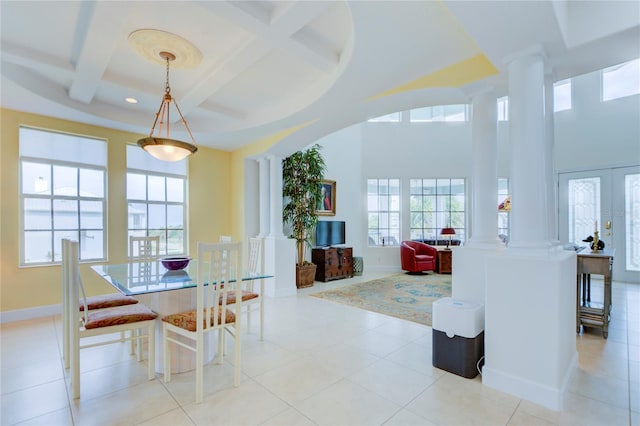 tiled dining area with french doors, beamed ceiling, coffered ceiling, and decorative columns