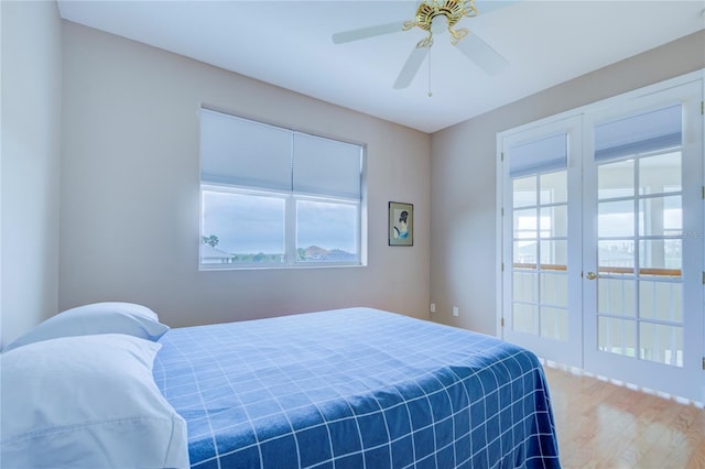 bedroom with ceiling fan, hardwood / wood-style flooring, and french doors