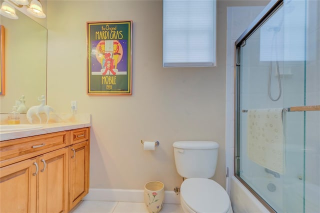 full bathroom with toilet, bath / shower combo with glass door, tile patterned floors, and vanity