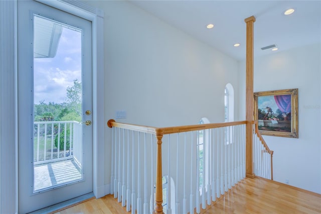 corridor with light hardwood / wood-style floors