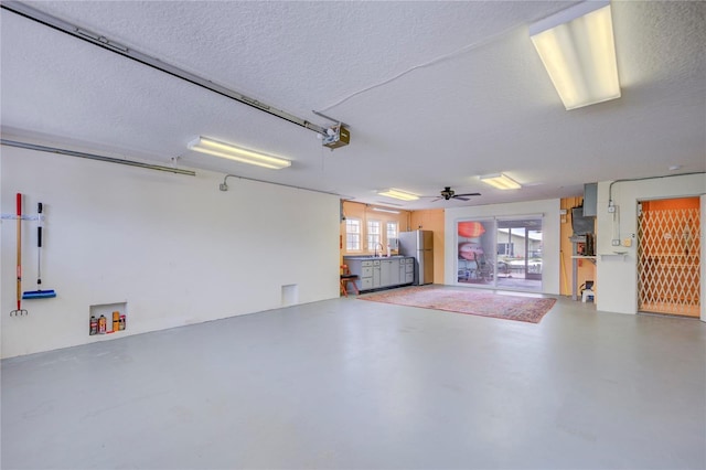 garage featuring stainless steel fridge and sink