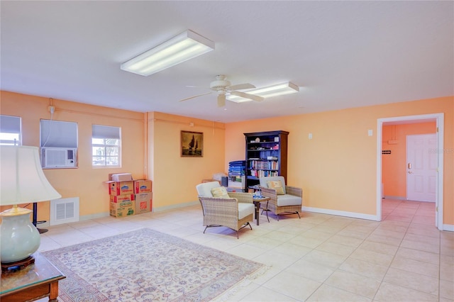 living area featuring ceiling fan and light tile patterned flooring