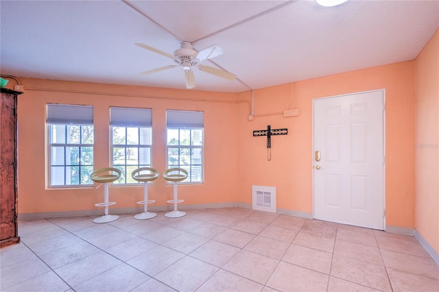 interior space featuring ceiling fan and light tile patterned floors