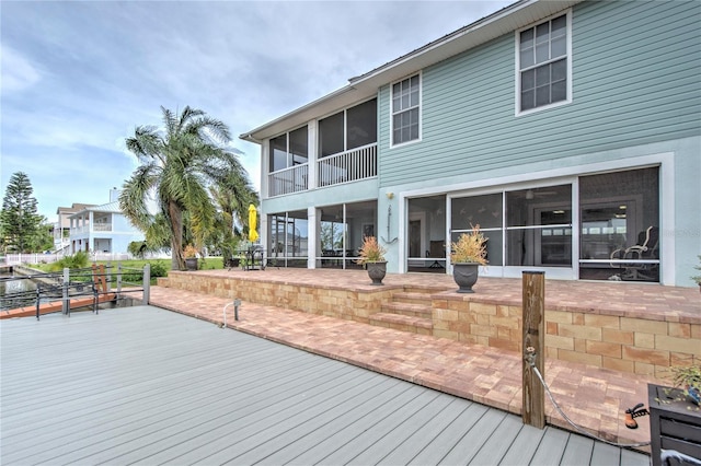 wooden deck with a sunroom