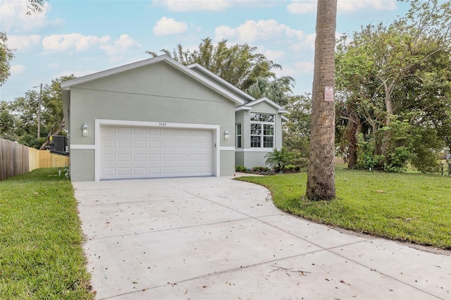 single story home with a front lawn, central AC unit, and a garage