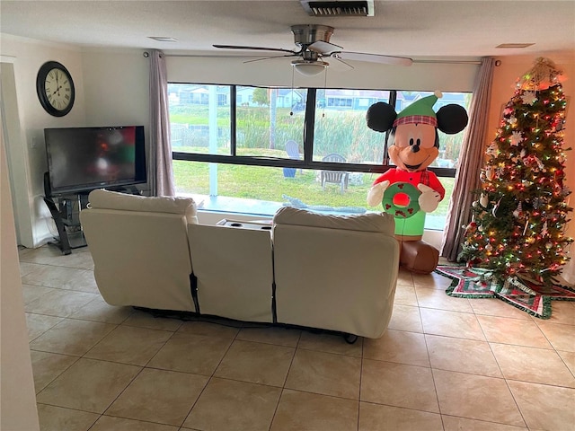 tiled living room featuring ceiling fan