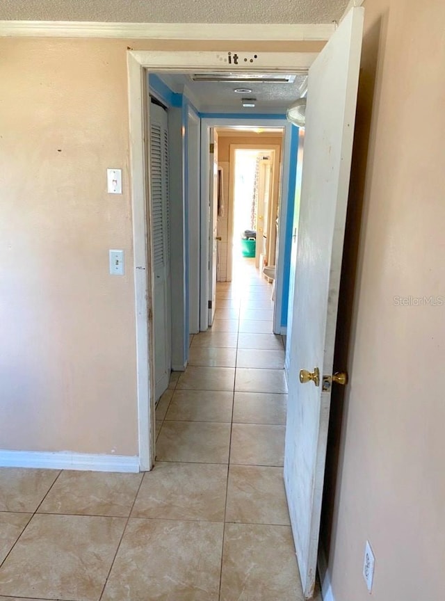 corridor featuring light tile patterned flooring