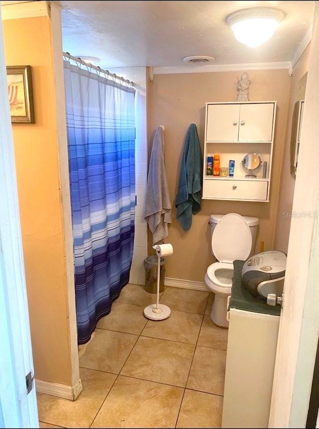 bathroom with tile patterned floors, ornamental molding, vanity, toilet, and curtained shower