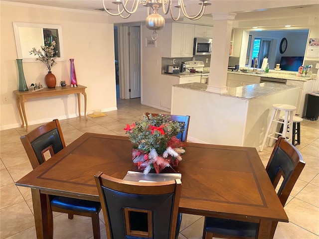 dining room with a notable chandelier, light tile patterned floors, and sink