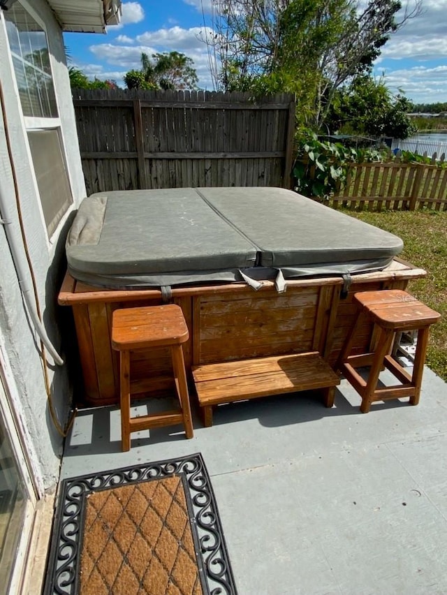 exterior space with a hot tub