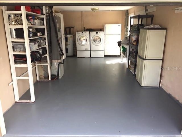 garage with white refrigerator, separate washer and dryer, and water heater