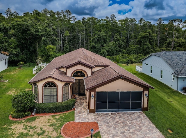 view of front of house with a front yard and a garage