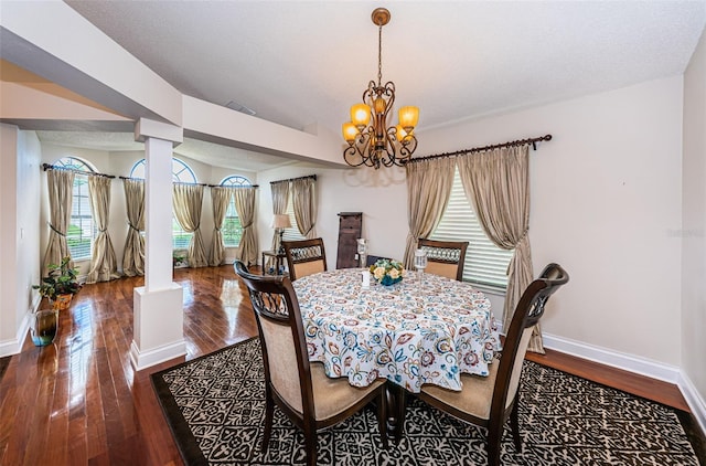 dining space with a chandelier, dark hardwood / wood-style flooring, and a wealth of natural light