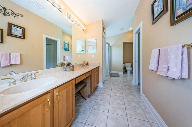 bathroom featuring tile patterned floors, vanity, and toilet