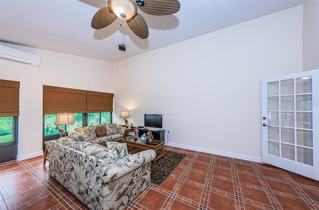 living room with ceiling fan and a wall mounted AC