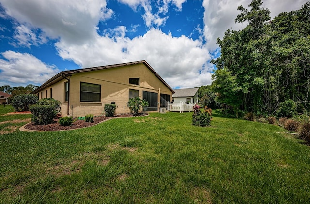 view of side of property with a yard