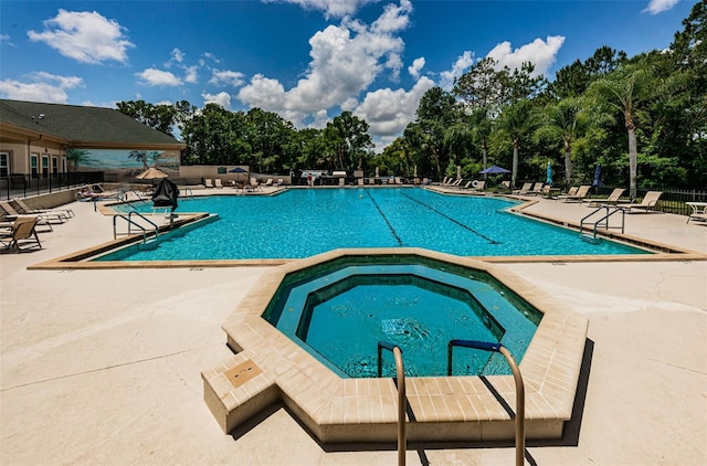 view of swimming pool featuring a patio area and a community hot tub