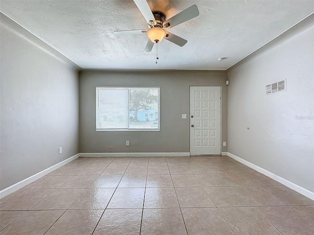 unfurnished room with light tile patterned floors, a textured ceiling, and ceiling fan