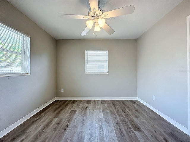 spare room with ceiling fan and dark wood-type flooring