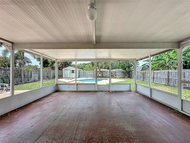 unfurnished sunroom featuring beamed ceiling