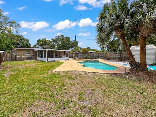 view of swimming pool featuring a yard, a patio, and a sunroom