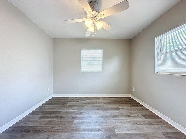 unfurnished room with baseboards, ceiling fan, and wood finished floors