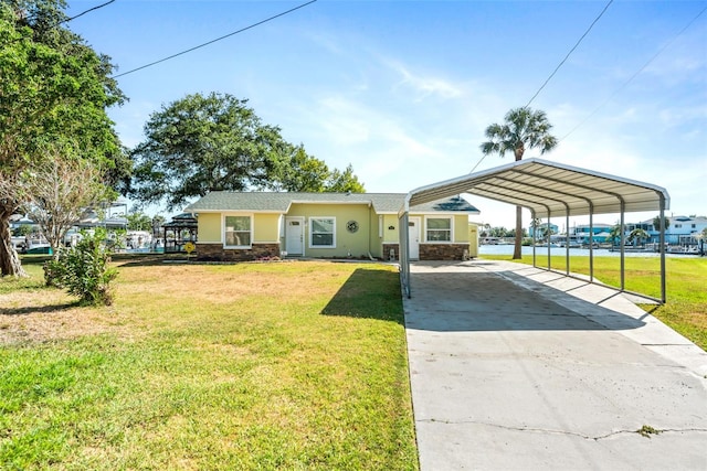 view of front of house with a front yard and a carport