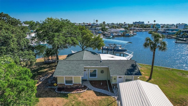 birds eye view of property with a water view